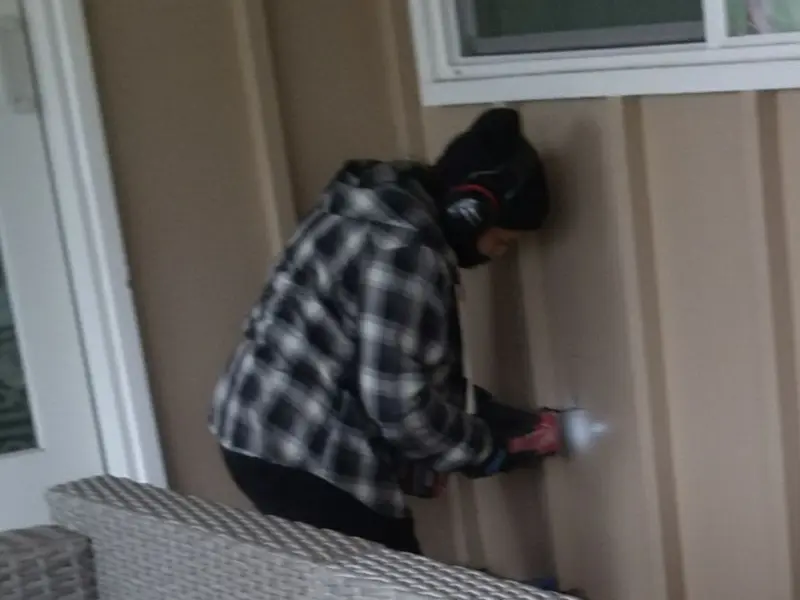 Professional electrician installing an exterior outlet in Palm Tree