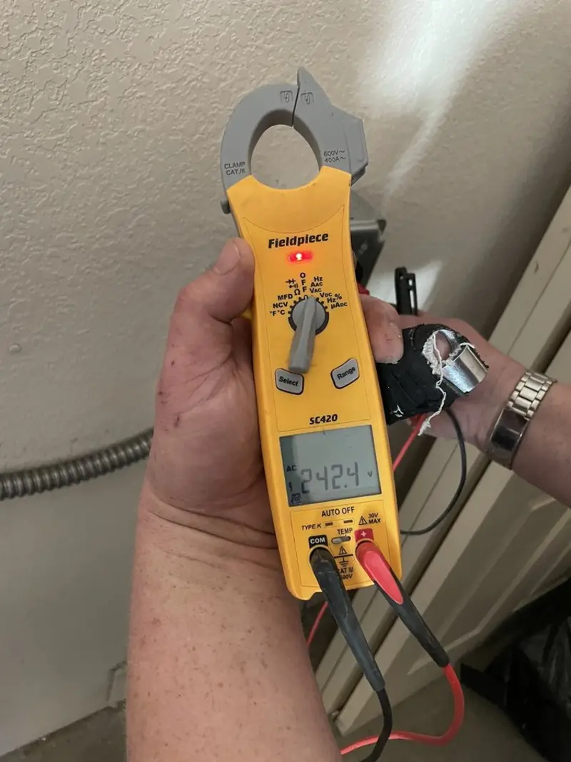 Voltage testing with clamp meter during Ceiling Fan Installation in Palm Tree